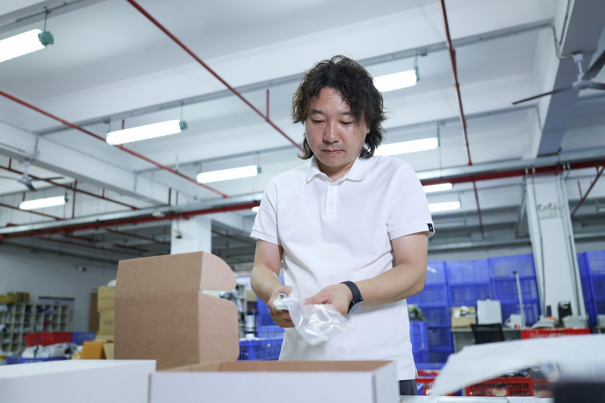 Fulfillment staff checking order data and packing requirements during a pilot