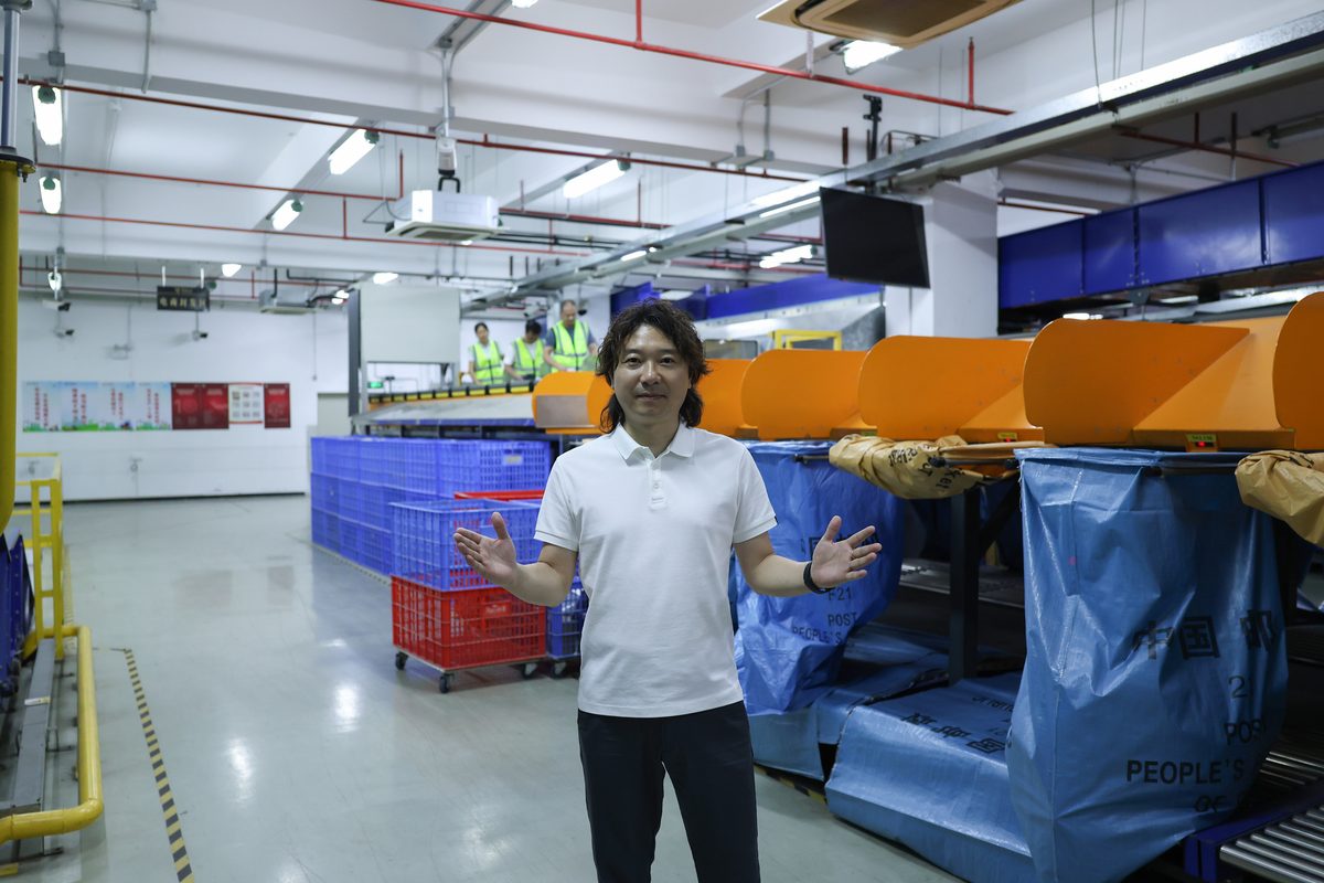Janson standing beside the ASG warehouse sorting line