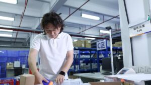 Janson checking a packed order at an ASG warehouse workstation