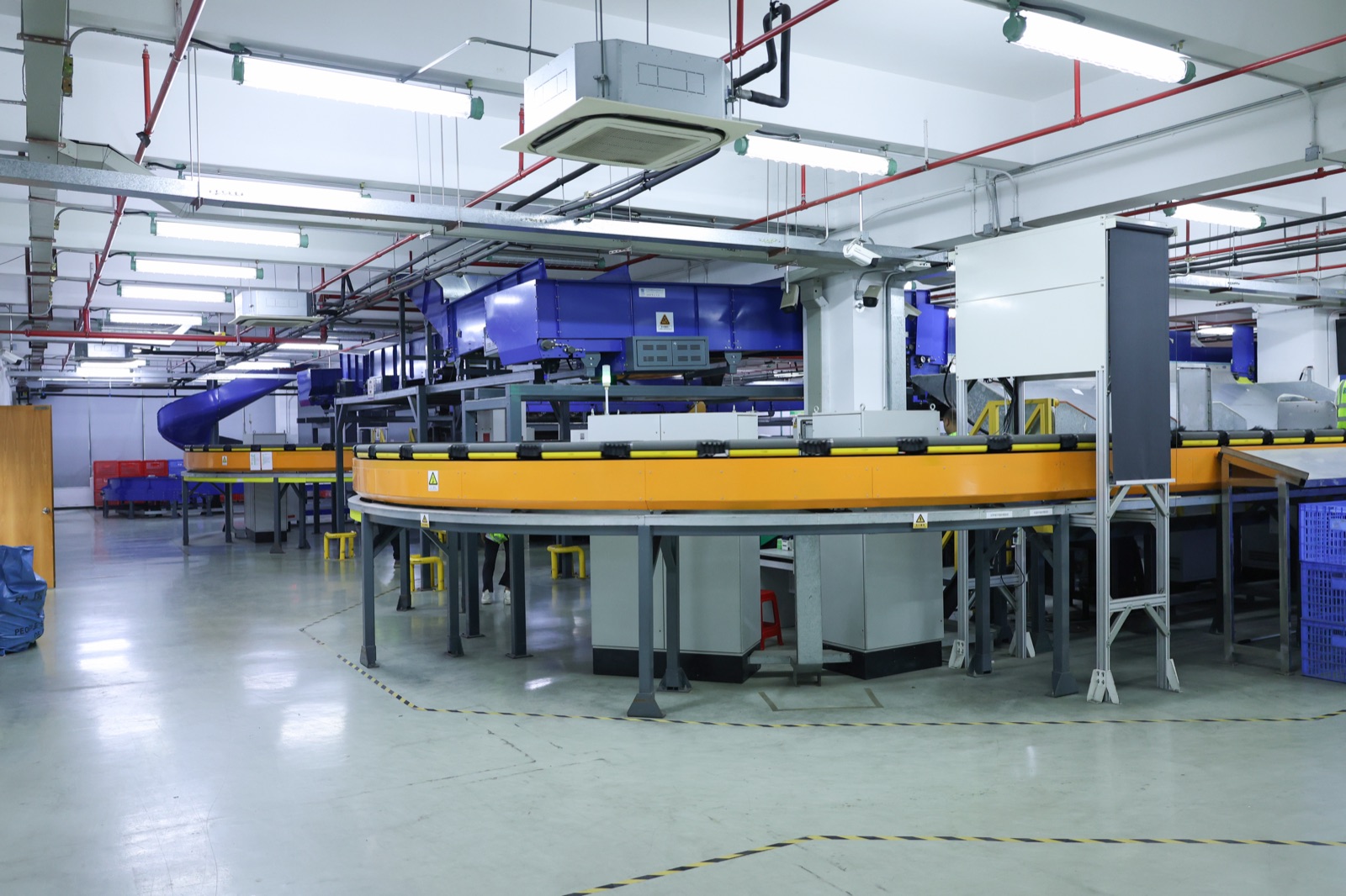 Warehouse sortation equipment and work areas seen across an ASG warehouse floor.