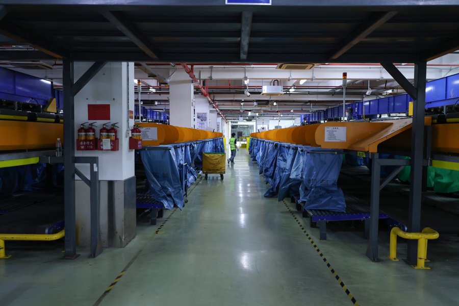 A sorting aisle lined with blue parcel bags