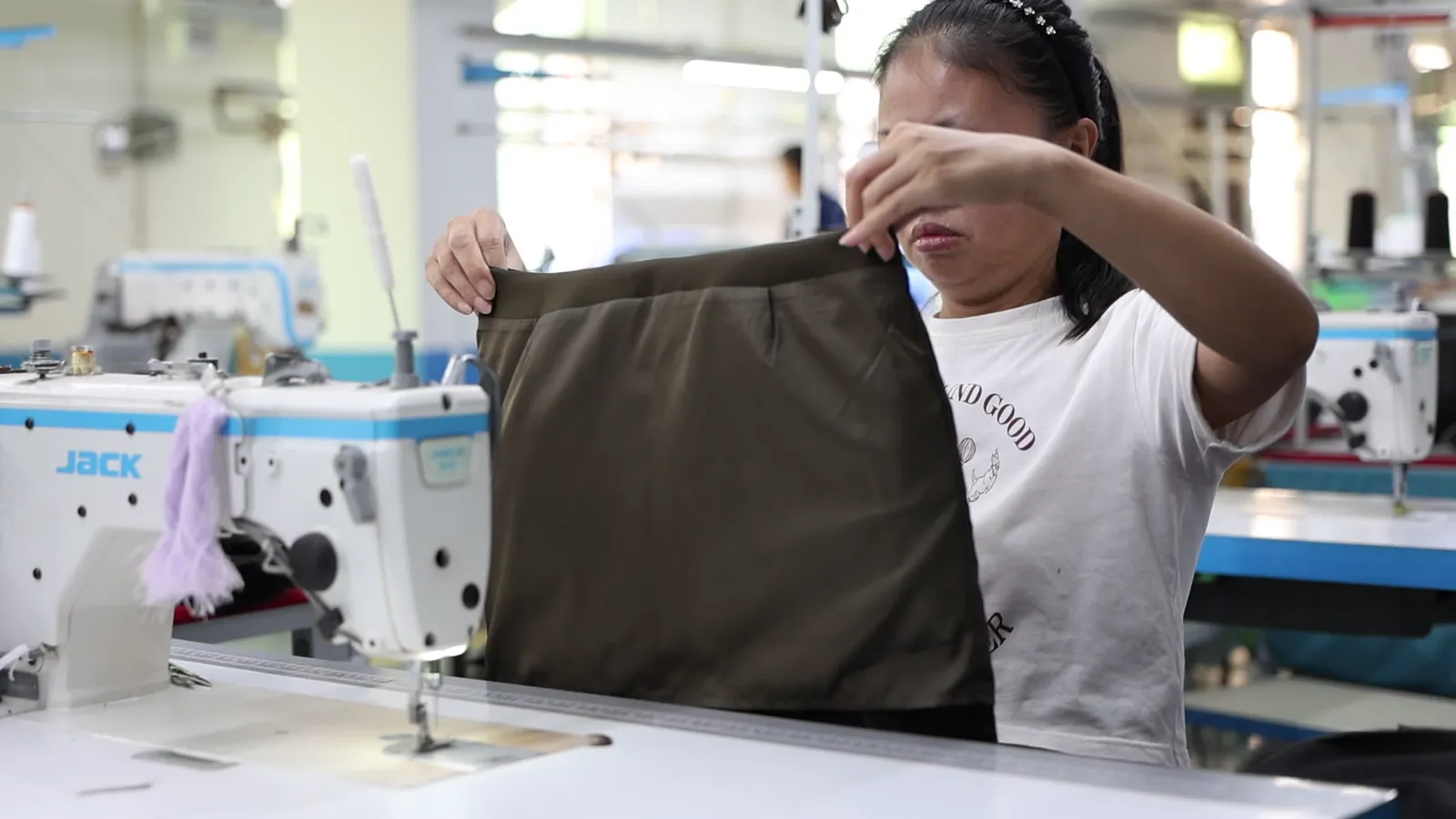 Inspector checking a finished garment at the end of the line