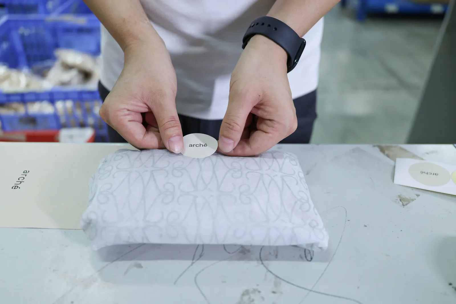 Sticker seal applied to a wrapped order before boxing