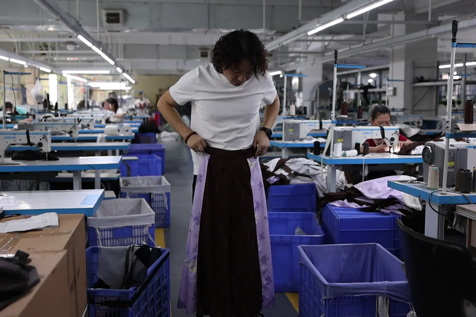 Founder Janson Wang checking a sample garment on the production floor
