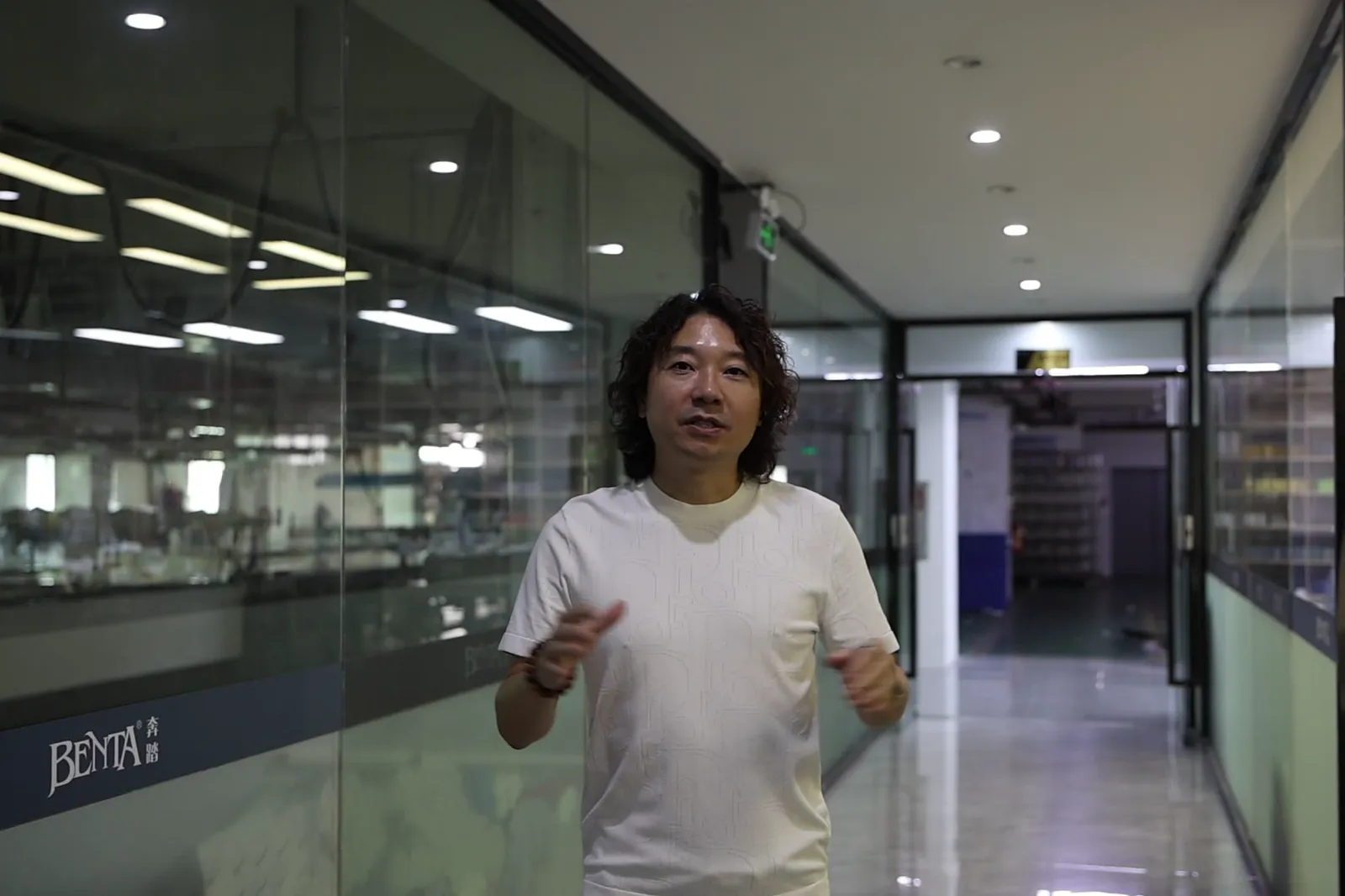 Founder Janson Wang walking through a supplier's office corridor
