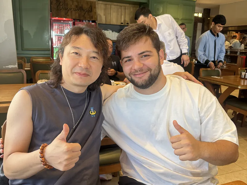 Founder Janson Wang with a client over lunch